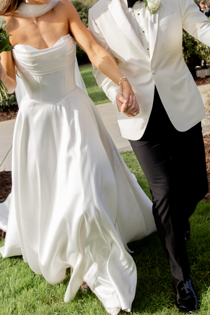 Cropped photo of bride and groom exiting their ceremony after their first kiss as husband and wife in Raleigh, NC.